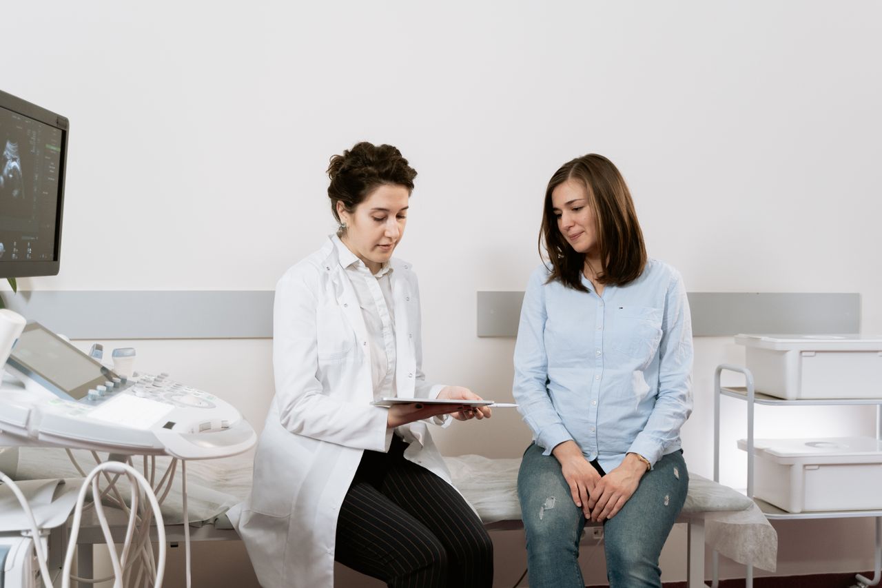 Femme enceinte en consultation avec une sage-femme pour le suivi de sa prise de poids